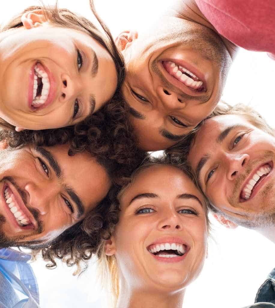Smiling person showcasing white teeth after laser whitening treatment 